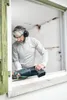A man is using a reciprocating saw to cut a window frame. Voir les images du produit
