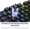 A close-up view of a mechanical keyboard with a highlighted switch mechanism, showcasing its internal components and RGB lighting. Produktbild-Vorschau