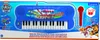 The image shows the retail packaging of a Paw Patrol electronic keyboard with a microphone. The packaging features colorful graphics of the Paw Patrol characters and the product itself. Produktbild-Vorschau