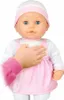 A baby doll wearing a pink and white outfit and hat, with a child's hand resting on its chest. Podgląd zdjęcia produktu