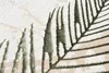 A close-up view of a rug with a leaf pattern. Produktbild-Vorschau