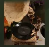 A close-up of a wooden model gramophone with a vinyl record playing. Podgląd zdjęcia produktu