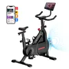 A stationary exercise bike with a tablet mounted on the handlebars, and a smartphone showing fitness apps to the side. Náhled obrázku produktu