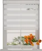 A white roller blind with horizontal stripes of sheer and opaque fabric is shown covering a window. A vase of orange tulips sits on the windowsill below the blind. Produktbild-Vorschau