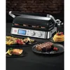 A grill with food items like steak, salmon, grilled vegetables, and pancakes arranged around it. Anteprima dell’immagine prodotto