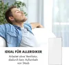 A man relaxing on a couch with his eyes closed, implying comfort and well-being. Produktbild-Vorschau