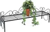 A black metal plant stand with a potted plant on it. Anteprima dell’immagine prodotto