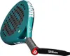 A teal colored padel racket with black grip and white branding, shown from a low angle. Produktbild-Vorschau