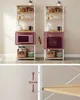 A split image showing two identical shelving units for kitchens, with one unit displaying a pink microwave and the other a dark red toaster oven. The bottom section shows a close-up of the shelving unit with a measurement indicating adjustability. Náhled obrázku produktu