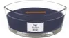 A dark blue WoodWick candle in a clear glass container. Podgląd zdjęcia produktu