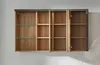 An open wall-mounted cabinet with wooden shelves and a gray frame, mounted on a white brick wall. Produktbild-Vorschau