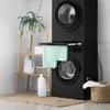 A laundry room with a stacked washer and dryer. Náhľad obrázku produktu