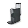 A black Tchibo Qbo coffee machine with a transparent water tank is shown against a white background. Produktbild-Vorschau