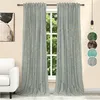 Two light blue velvet curtains with gold print are hanging in front of a window. A white armchair is visible to the left. A small lamp hangs from the ceiling on the right. Produktbild-Vorschau