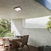 An outdoor patio with a table and chairs under a concrete overhang, with a view of mountains in the background. Anteprima dell’immagine prodotto