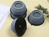 Four gray anti-vibration pads for a washing machine are arranged on a light gray surface. Voir les images du produit