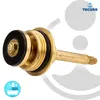 A brass valve part with black rubber seals, isolated on a white and light gray background with graphic elements. Produktbild-Vorschau