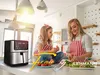 A mother and daughter are in a modern kitchen preparing food next to an air fryer. Voir les images du produit