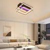 A modern living room with a sectional sofa, coffee table, and a stylish ceiling light. Voir les images du produit