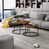 A modern living room with a sectional sofa, coffee tables, and a bookshelf. Anteprima dell’immagine prodotto