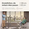 A man and a woman are shown using height-adjustable desks in a modern office setting with a city view. Produktbild-Vorschau
