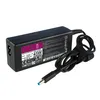A black laptop power adapter with a coiled cable and a blue connector. Produktbild-Vorschau