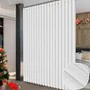 A white folding room divider curtain is shown in a room with a Christmas tree and gifts on the left, and a bed with pillows on the right. Voir les images du produit
