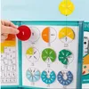 A hand holding a red fraction piece above a board displaying various fraction pieces and charts. Náhľad obrázku produktu