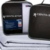 A folded white duvet is shown in front of two black carrying bags with the brand logo and product name visible. Produktbild-Vorschau
