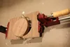A woodworking clamp holding a circular wooden object. Anteprima dell’immagine prodotto