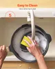 A person is washing a pan in a sink with soapy water. Anteprima dell’immagine prodotto