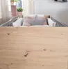A baby crib with pillows and a star-shaped cushion. Produktbild-Vorschau