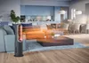 A modern living room with a sofa, coffee table, and kitchen in the background, featuring a space heater. Podgląd zdjęcia produktu