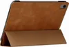 The back of a tan leather iPad case is shown, propped up in a stand position. Produktbild-Vorschau