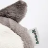 A close-up of a plush toy's ear and a tag with the brand name. Produktbild-Vorschau