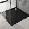 A close-up view of a black shower tray with anti-slip texture inside a modern bathroom. Produktbild-Vorschau