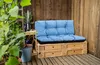 An outdoor seating area with a pallet sofa and plants. Náhľad obrázku produktu