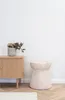 A side table and a cabinet with a vase of dried flowers on it, set against a white wall. Podgląd zdjęcia produktu