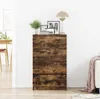 A wooden sideboard in a room with a lamp and pictures on top. Podgląd zdjęcia produktu
