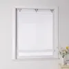 A white Roman blind is installed in a white window frame. A small vase with flowers sits on a nightstand to the right of the window. Produktbild-Vorschau