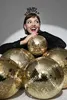 A woman wearing a 'Happy New Year' headband is surrounded by gold disco balls. Anteprima dell’immagine prodotto