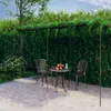 A garden pergola with a table and chairs set up on a patio. Náhled obrázku produktu