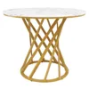 A round dining table with a marble-effect top and a gold, twisted metal base, presented on a white background. Voir les images du produit