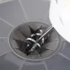 A close-up view of a mixer attachment inside a gray container. Produktbild-Vorschau