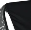 A close-up view of a dog stair with a zipper partially open, revealing the white interior. The exterior fabric has a pattern of paw prints and bones. Produktbild-Vorschau