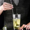 A person is making a cocktail in a glass shaker. Produktbild-Vorschau
