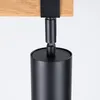 A close-up shot of a black cylindrical light fixture hanging from a wooden beam. Podgląd zdjęcia produktu