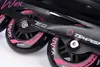 Close-up view of the wheels and frame of black inline skates with pink accents. Voir les images du produit