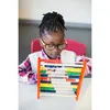 A young girl wearing glasses is focused on using a colorful abacus. Produktbild-Vorschau
