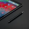 A black stylus pen lies on a black surface next to a tablet displaying a colorful home screen. Produktbild-Vorschau